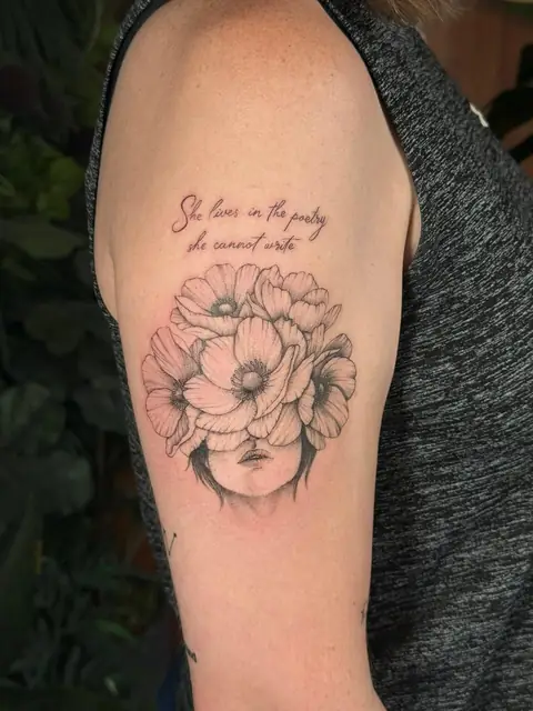 Anemones covering the face, with “She lives in the poetry she cannot write” above.