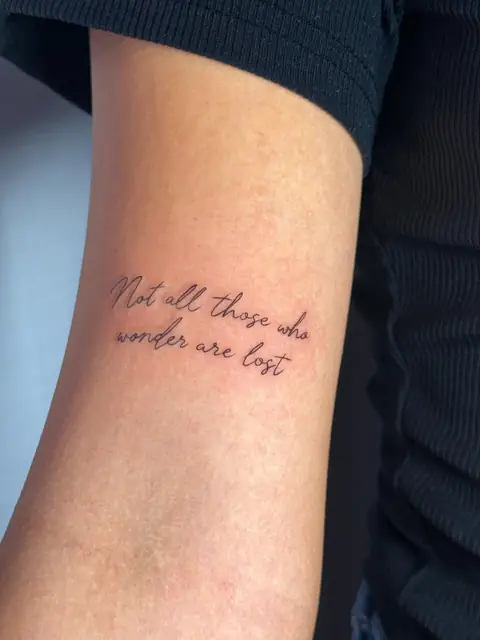 Script lettering: “Not all those who wonder are lost.”
